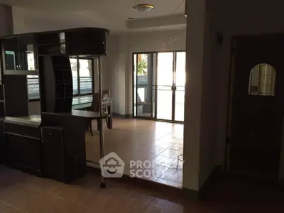Spacious open-plan living area with large windows and modern furnishings.