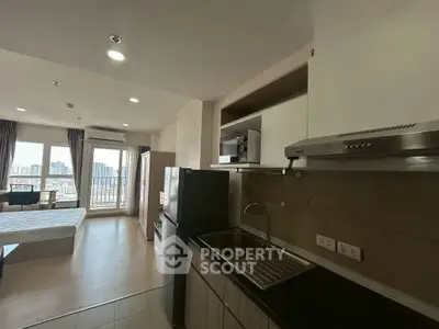 Modern studio apartment with open kitchen and city view balcony