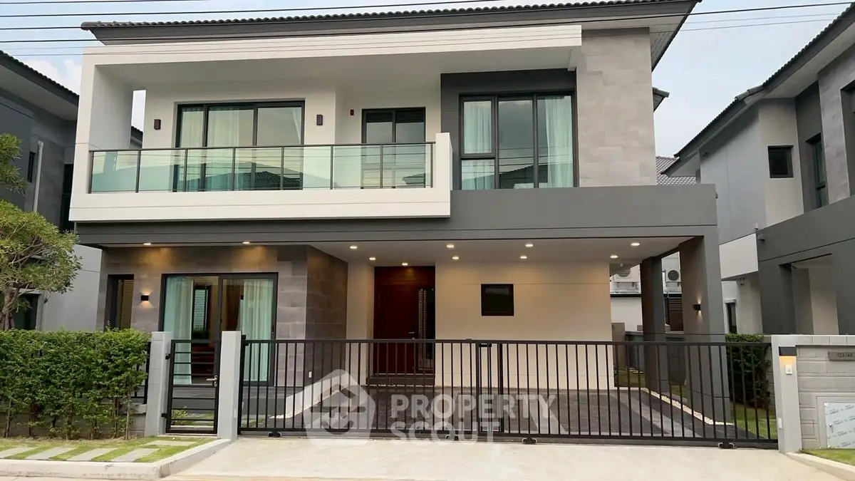 Modern two-story house with spacious balcony and sleek exterior design