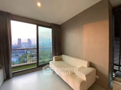 Modern living room with stunning city view and cozy sofa, perfect for relaxation.