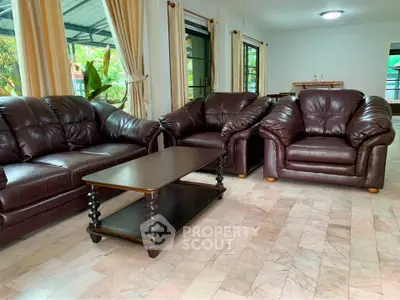 Spacious living room with elegant leather sofas and natural light