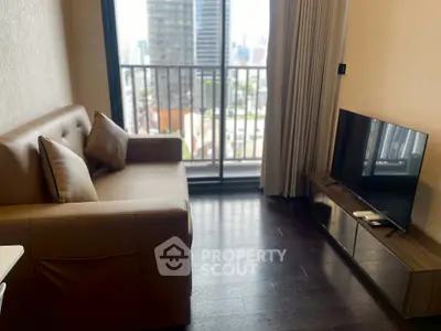 Modern living room with city view and sleek furnishings in high-rise apartment.
