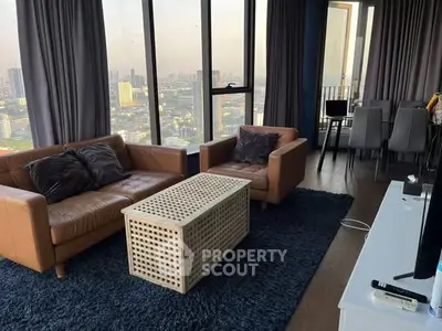 Luxurious high-rise living room with stunning city view and modern furnishings.