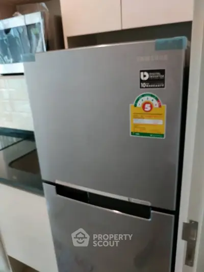 Modern kitchen with sleek Samsung refrigerator and built-in oven.