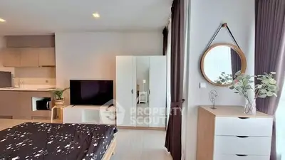 Modern bedroom with stylish decor, featuring a cozy bed, sleek wardrobe, and elegant mirror.