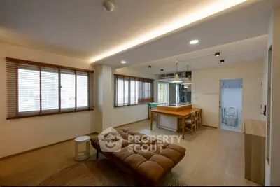 Spacious living room with modern open kitchen and natural light