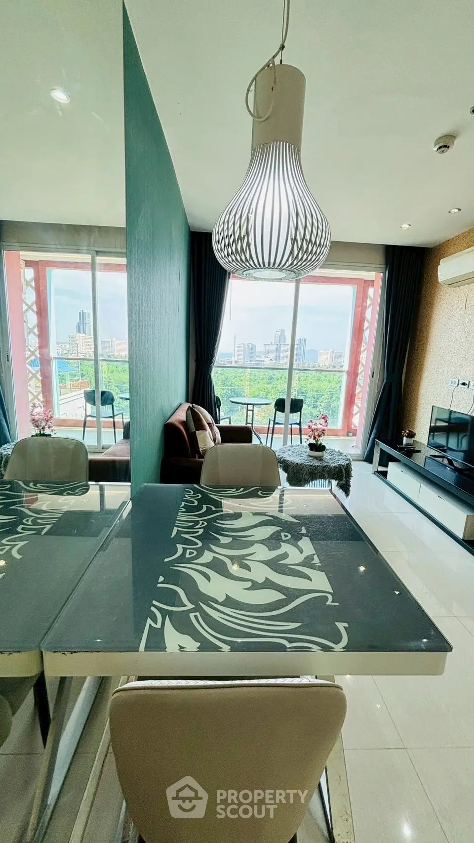 Modern living room with city view, stylish decor, and elegant lighting in high-rise apartment.