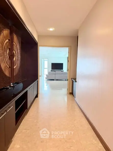 Spacious hallway leading to a modern living room with elegant decor.