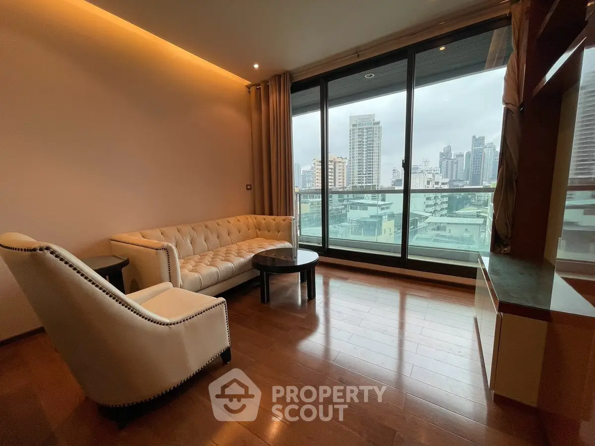 Luxurious living room with elegant furniture and stunning city view from large windows.