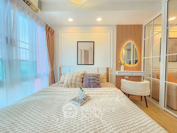 Luxurious bedroom with elegant decor and natural light, featuring a cozy bed and stylish furnishings.