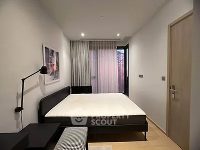 Modern bedroom with minimalist design, featuring a large bed, stylish lighting, and floor-to-ceiling window.