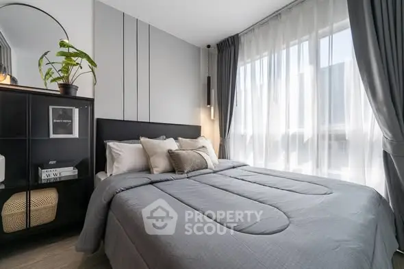 Modern bedroom with large window and stylish decor