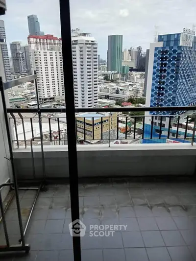High-rise balcony with stunning cityscape view in modern urban setting.