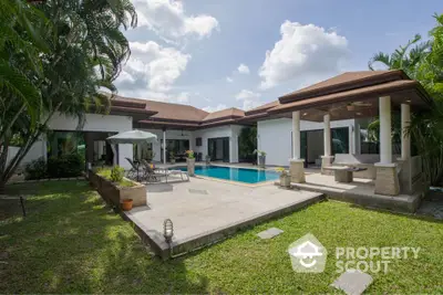 Luxurious villa with private pool and lush garden in tropical paradise setting.