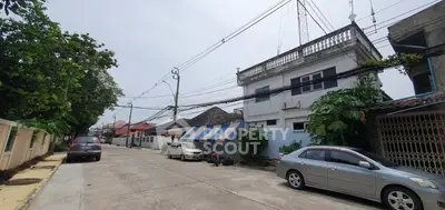 Charming residential street with parked cars and traditional houses, ideal for serene living.