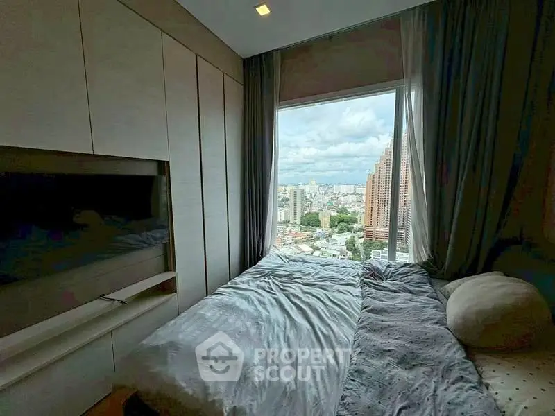 Cozy bedroom with large window offering stunning city view