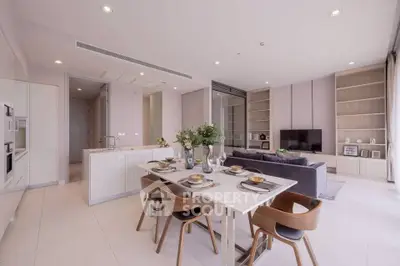 Luxurious open-plan living and dining area with modern kitchen in a stylish apartment.