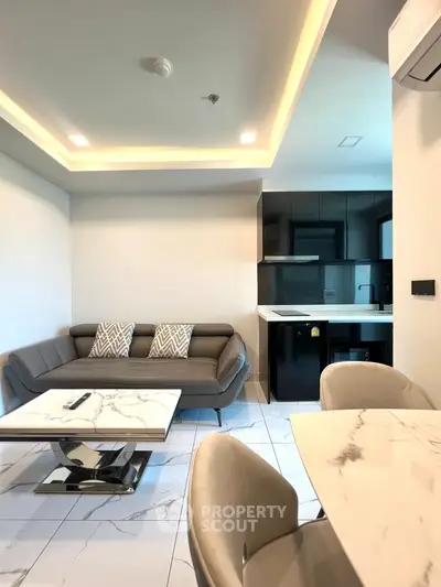 Modern living room with sleek furniture and open kitchen layout