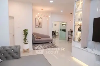 Modern living room with elegant decor and open layout, featuring stylish lighting and cozy seating area.