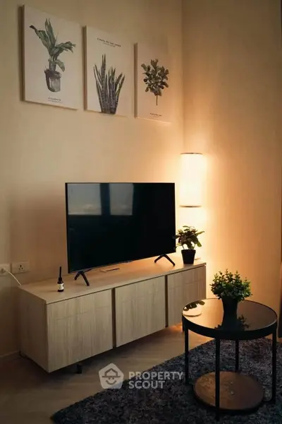 Modern living room with stylish decor and flat-screen TV on wooden stand