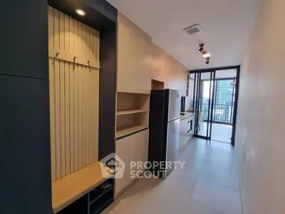 Modern kitchen with sleek cabinetry and balcony view in urban apartment