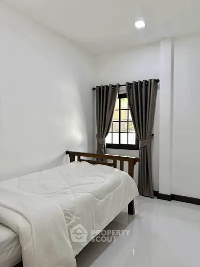 Cozy minimalist bedroom with natural light and modern decor