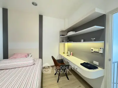 Modern bedroom with built-in desk and shelves, featuring sleek design and ample storage space.