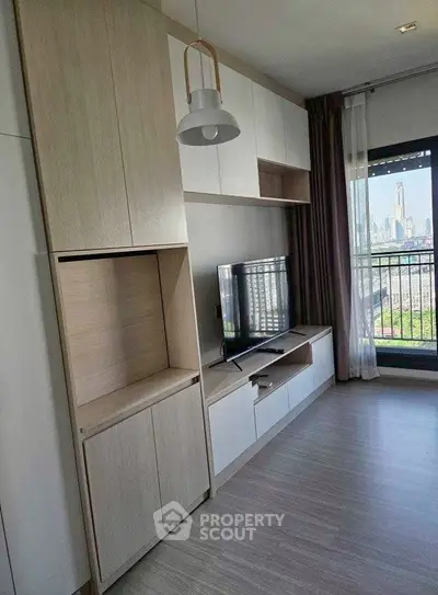 Modern living room with built-in storage and city view balcony.