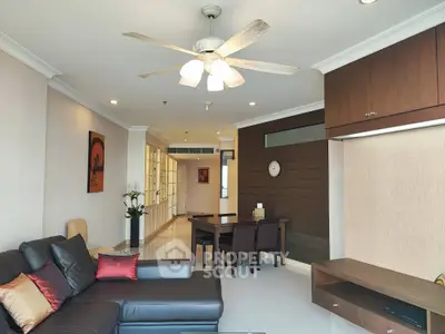 Spacious living room with modern decor and ceiling fan, ideal for family gatherings.