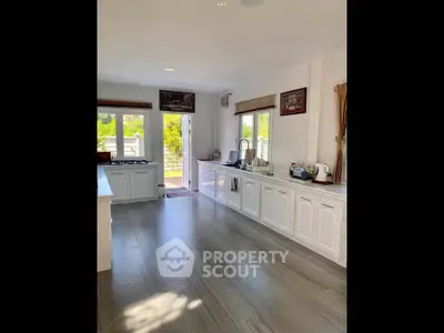 Spacious kitchen with modern appliances and large windows for natural light