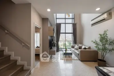Spacious modern living room with high ceilings and city view, featuring elegant decor and natural light.