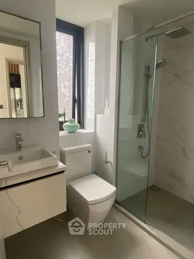Modern bathroom with sleek fixtures and glass shower enclosure