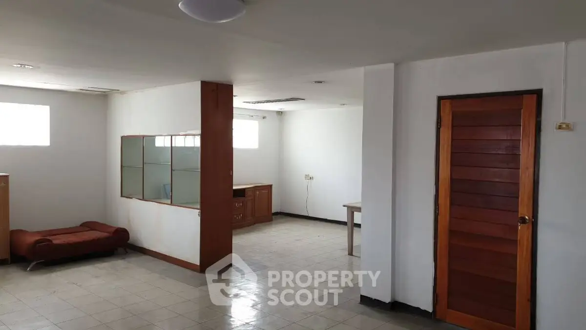 Spacious interior with natural light and wooden accents, ideal for versatile living arrangements.
