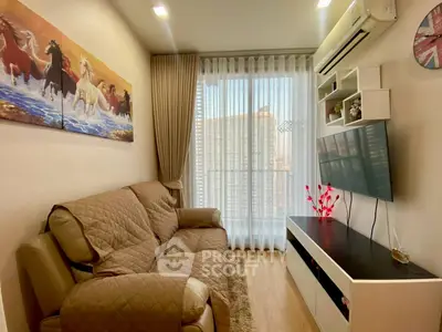 Cozy living room with modern decor, large window, and mounted TV in a stylish apartment.