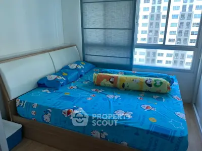 Cozy bedroom with large window and vibrant bedding in modern apartment.