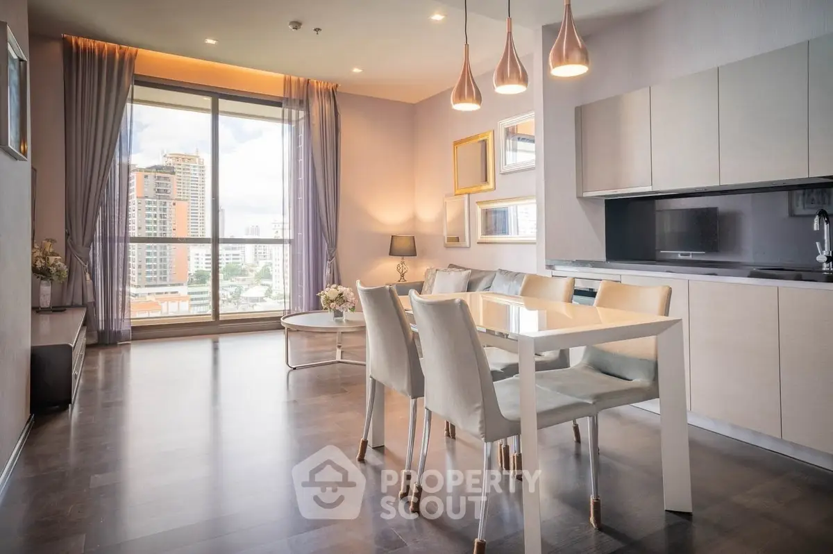 Spacious modern living room with dining area and large window offering city views.