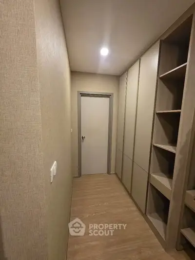 Modern storage room with sleek built-in cabinets and wooden flooring