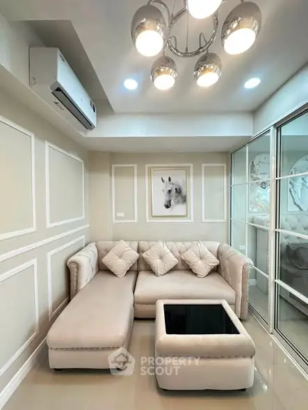 Elegant living room with plush sectional sofa and modern lighting, perfect for cozy gatherings.