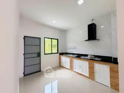 Modern kitchen with sleek countertops and ample natural light