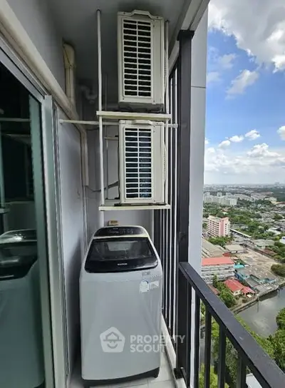 High-rise balcony with washing machine and city view, perfect for urban living convenience.