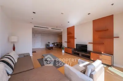 Spacious living room with modern furniture and wooden accents, perfect for relaxation and entertainment.