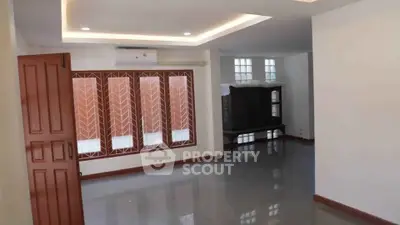 Spacious open-plan living room with modern finishes and large windows.