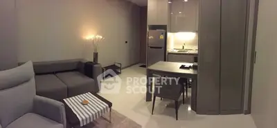 Modern living room with cozy seating and compact kitchen area