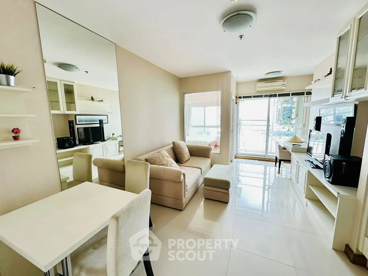 Modern living room with sleek design, cozy sofa, and large window offering natural light and a view.