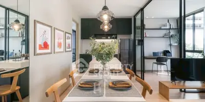 Modern dining area with elegant decor and open layout, featuring stylish lighting and contemporary furnishings.