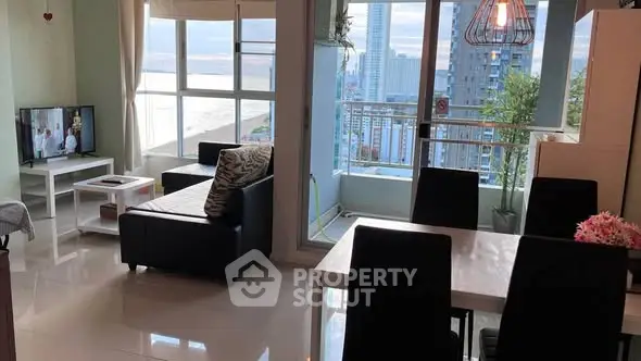 Spacious living room with stunning city and ocean view, modern furniture, and elegant dining area.