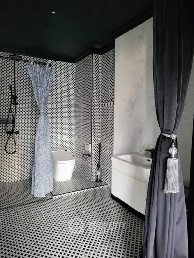 Elegant modern bathroom with stylish black and white decor and luxurious fixtures.
