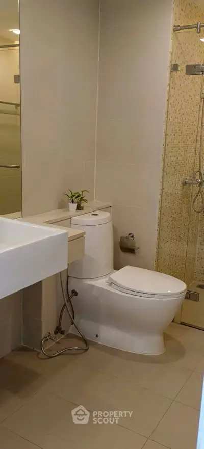 Modern bathroom with sleek fixtures and glass shower enclosure