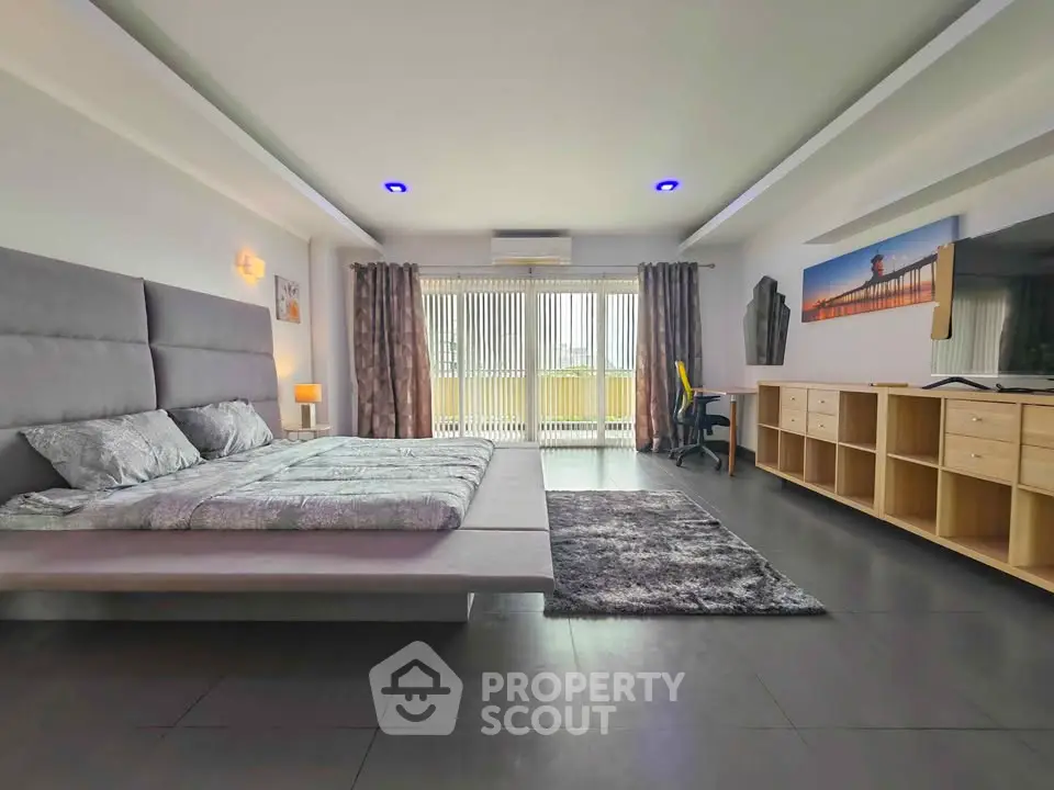 Spacious modern bedroom with sleek design and ample natural light