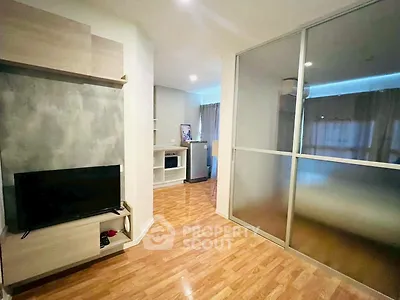 Modern living room with wooden flooring and sliding glass partition